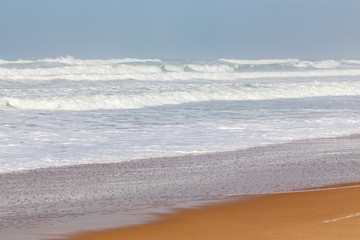 Ocean coast, moviment waves with foam. Wind power. Turquoise water.