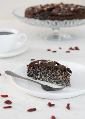 A slice of poppy cake on a white plate