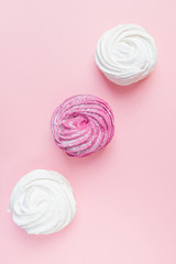 Fresh vanilla and berry marshmallows on a pastel pink background. The concept of home-cooked food, sweets. Minimalism, top view, flat lay, copyspace.