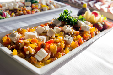 Tray with appetizer for buffet with cheese peppers and pine nuts