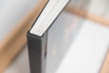 Close up view of photo album book binding - spine view of block - obrazy, fototapety, plakaty