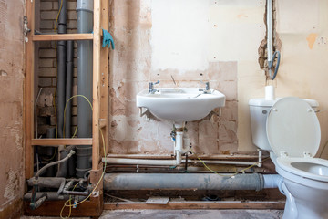 A bathroom stripped bare as it is being refurbished and modernised.