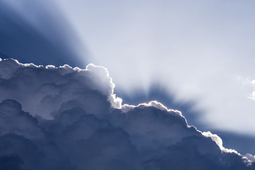 Clouds and Light. Sunlight backlights clouds with blue sky.