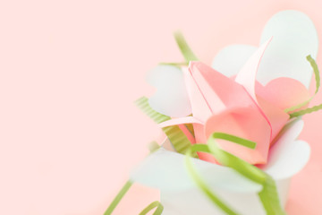 Flower banner. Close up composition of pink Origami paper tulip with green decorations in white box-heart on pink background