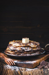 Russian pancakes with sugar, butter and chocolate, national food Russian blini, Shrovetide, pancakes on a wooden background, sweet dessert, vertical shot