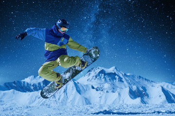night skating snowboarder doing trick under the starry sky and moonlight