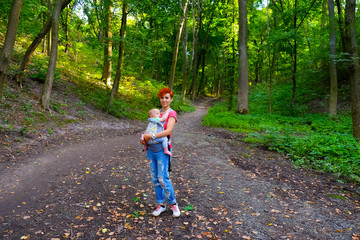Mother and son travel in nature park, forest, river sunny day. Woman, little baby boy, child, kid on vacation. Beautiful nature landscape. Family spend time together outdoors. Happy summer holidays.