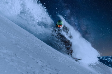 night skating snowboarder is going very fast in stream of snow avalanche under the starry sky and moonlight