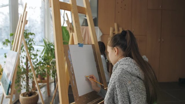 Lesson in art studio. Girls learn to draw still life.