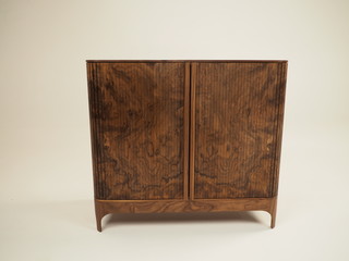 Original designer chest of drawers made of natural wood in its entirety, as well as its details on a white background, from different angles.
