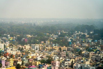 Fototapeta na wymiar View of Fog In the Early Morning Over Colorful Bangalore Neighborhood in India