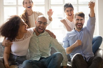 Excited overjoyed friends shouting with joy celebrating sport team win