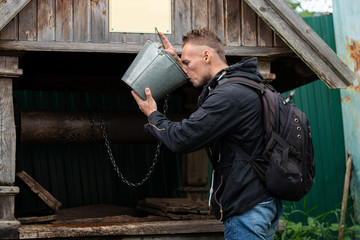 Man drinks from well with water
