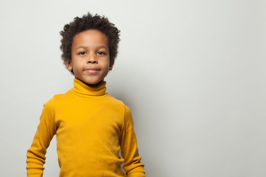 Portrait of smart little black kid boy on white background