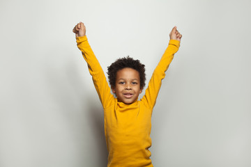 Little black kid boy having fun on white background