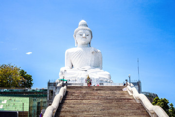 White marble statue of Phuket Big Buddha by blue sky in Thailand
