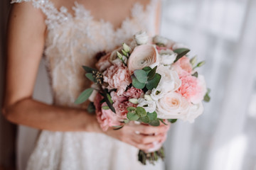 Brides wedding bouquet in women's hands. wedding flowers
