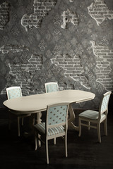 A set of furniture for the kitchen in the loft interior. A collection of chairs and tables for dinner in the family circle.