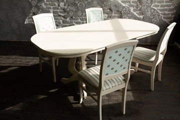 A set of furniture for the kitchen in the loft interior. A collection of chairs and tables for dinner in the family circle.
