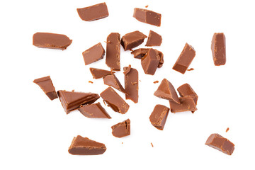 milk chocolate broken into pieces isolated on a white background. top view