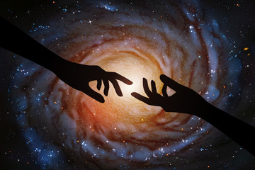 Reaching hands and spiral galaxy in outer space. Romantic vector illustration with hand silhouette and astronomical object in cosmos. Dark starry background. Elements of this image furnished by NASA © arvitalya
