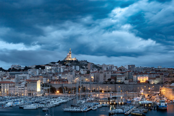Fototapeta premium Night Old Port and the Basilica of Notre Dame de la Garde on the background, on the hill, Marseille, France