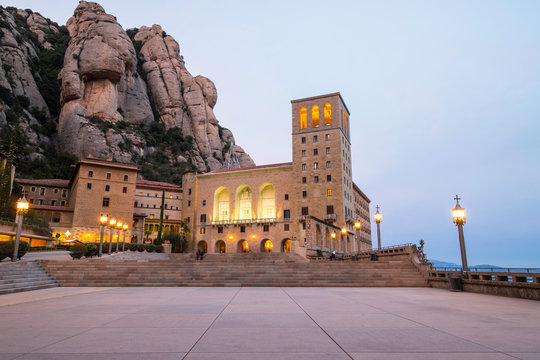Montserrat Monastery facade illuminated at twilight in Catalonia
