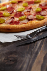 tasty pizza on the wooden background