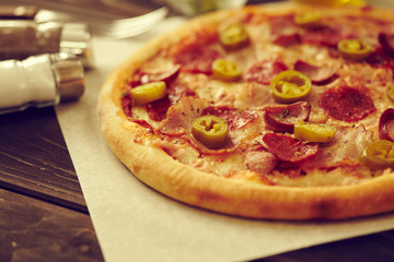 tasty pizza on the wooden background