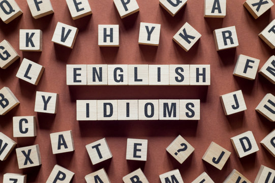 English idioms word concept on cubes