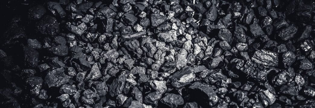 Coal miner in the man hands of coal background. Coal mining