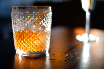 Old fashioned whiskey cocktail on wooden table 