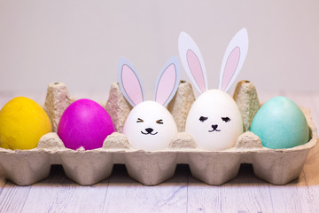 Easter eggs and cute rabbits in a cardboard box. happy Easter. concept.