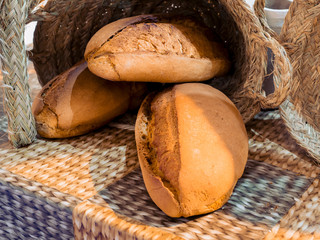 Rustic white bread loafs in a bakery shop