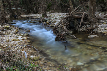 long exposure shot of flowing river in the forest. Landscape during autumn.