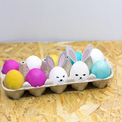 Easter eggs and cute rabbits in a cardboard box. happy Easter. concept.