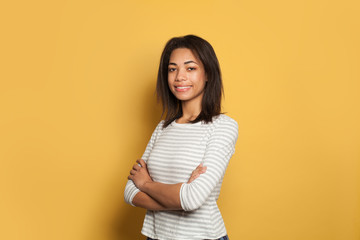 Obraz premium Cheerful black woman in white shirt on colorful yellow background