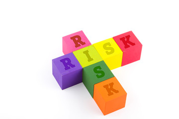 Risk concept using wooden blocks isolated on white.