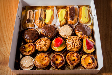 Varied miniature cakes in a white box. Traditional Portuguese cakes.