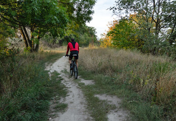 cyclist rides on a country path, outdoor activities