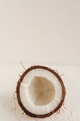 Half a coconut on a white background. Front view. Background with space for text.