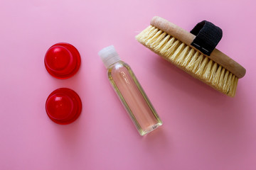 Spa organic brush for dry massage and a bottle of body oil on pink background. Cactus brush and Jar Of Vacuum Cellulite Massage. Anti-cellulite massage. Spa beauty concept