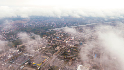 City through the clouds. Aerial view of autumn lanscape