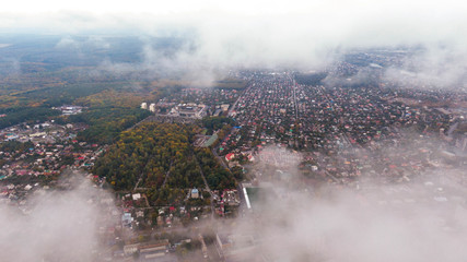 City through the clouds. Aerial view of autumn lanscape