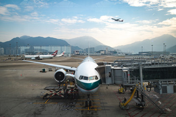 Fototapeta na wymiar Airplane docked at the Hong Kong International Airport