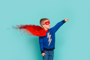 Little boy playing pretend to superhero. Happy young cut boy wearing hero costume, education...