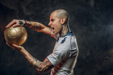 Bold and emotional soccer player posing for a photoshot in a dark studio, wearing professional...