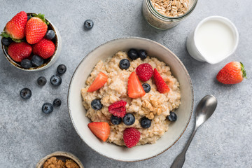 Bowl of oatmeal porridge with summer berries. Top view. Clean eating, dieting, weight loss concept