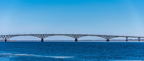 A fragment of the bridge across the Volga near Saratov in the spring with the remains of ice on the water