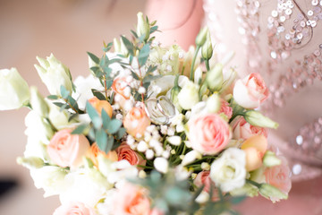 wedding rings on bride’s bouquet